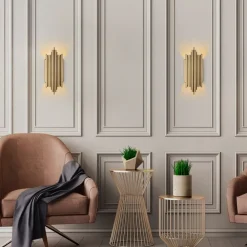 Vägglampa i guldutförande - Munspel